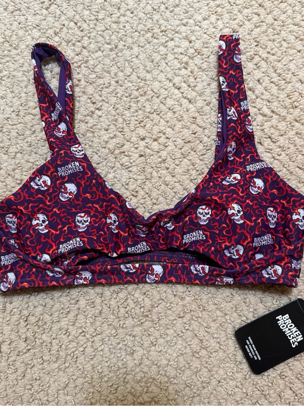 Broken Promises red & purple swim top with white skulls and red swirls size M